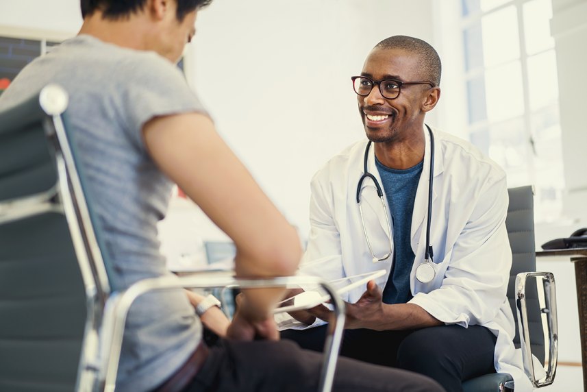 man talking to doctor about colonoscopy screening