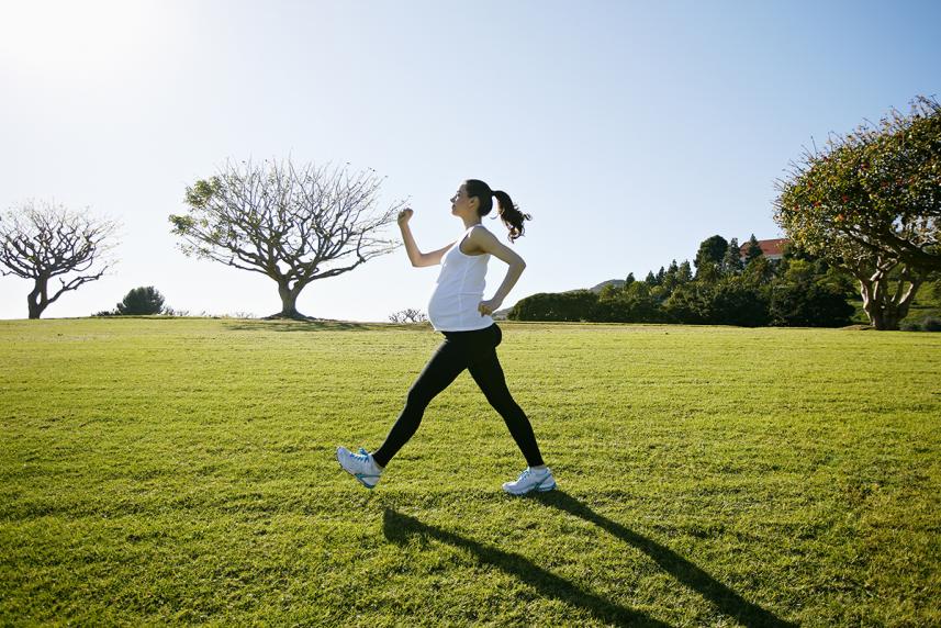 Pregnant woman power walking