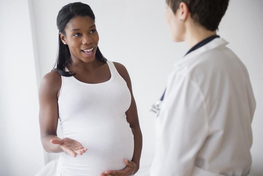 Pregnant woman talking to her doctor